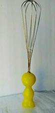 KOZIOL YELLOW FIGURE WHISK. 1997 MADE IN GERMANY DESIGN: ORANGE, DARMSTADT