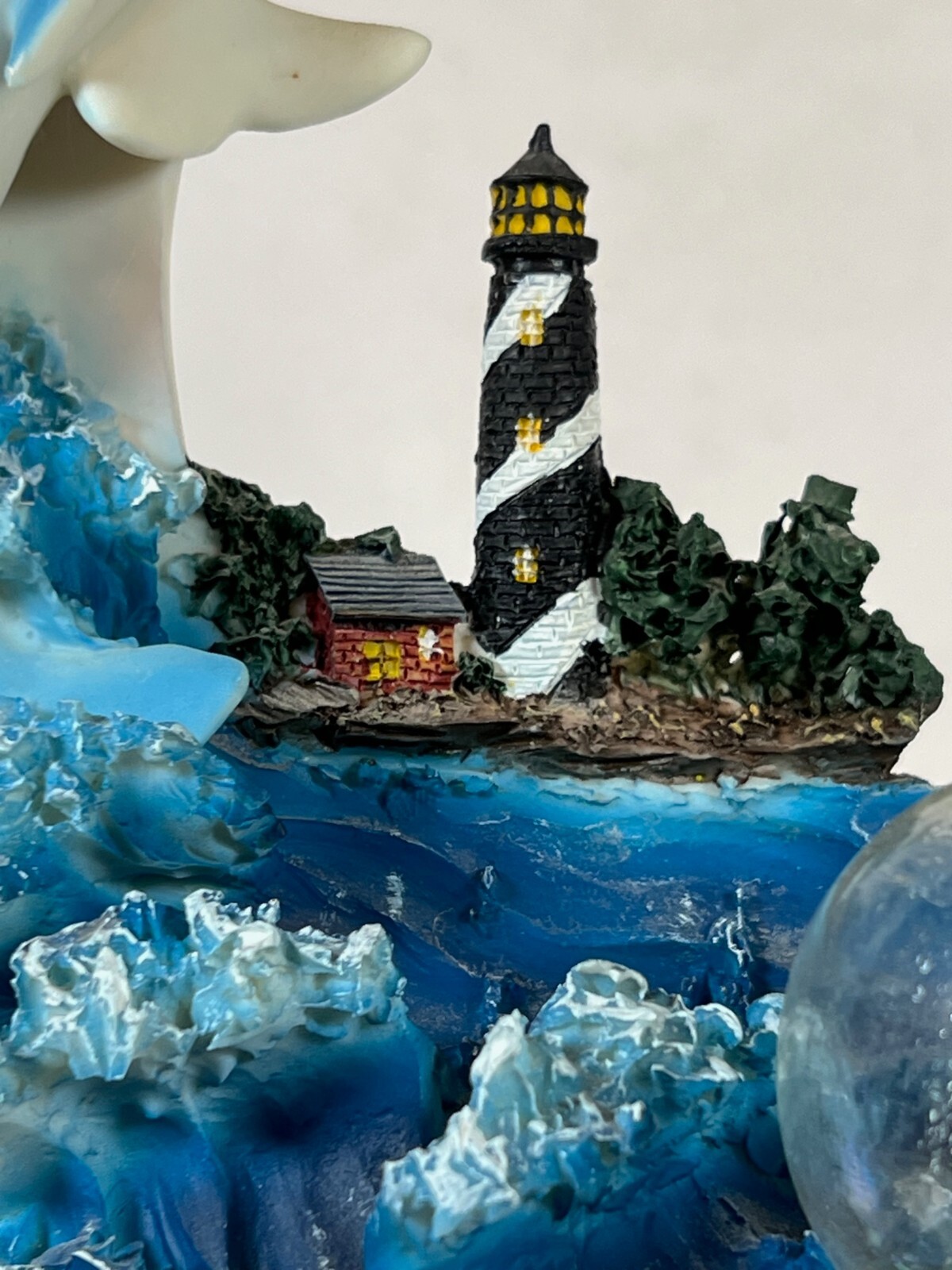 Large Ring of Dolphins swimming around a Light House