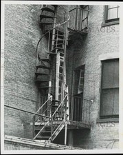 Press Photo Fire escape on Boston building used as storage area for stepladder
