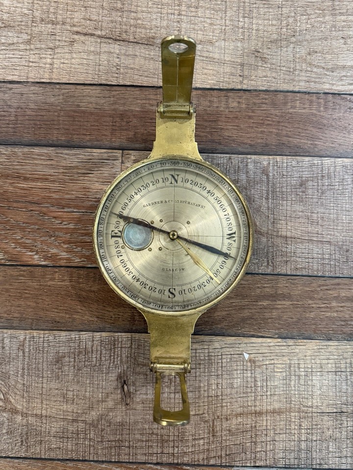 An antique brass surveyor's / miner's compass from Gardner Co., Glasgow — a stunning piece of precision engineering history with serious desk-trophy energy.