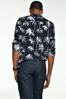 Man wearing navy blue denim jacket with white palm tree pattern, single chest pocket, size 40x33 bootcut.