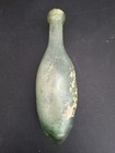Antique Green Glass Torpedo Bottle With Stuff Inside — photo 1