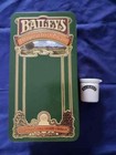 Vintage Baileys Original Irish Cream display tin with hinged lid and ceramic min