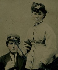 YOUNG COUPLE IN HATE, HER FEATHER, HIS GREEK FISHERMAN. TINTED TINTYPE.