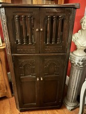 Jacobean / Gothic-style dark oak corner drinks cabinet