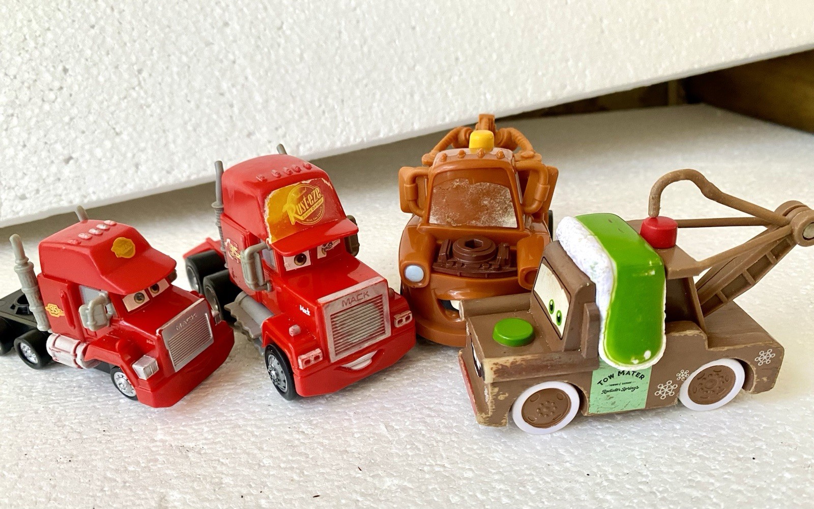 Mattel Disney Pixar Cars toy vehicles featuring Mack the Hauler and Tow Mater.