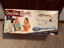 Easy bake oven in original packaging with food, working oven tray and spatula