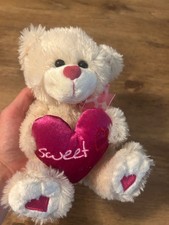 small valentines day teddy bear holding pink heart plushie