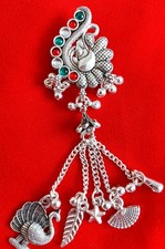 Oxidized silver-toned ethnic Saree pin featuring a peacock pendant.