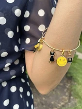 Gold Toned Stainless Steel Expandable Bangle With Yellow Themed Charm