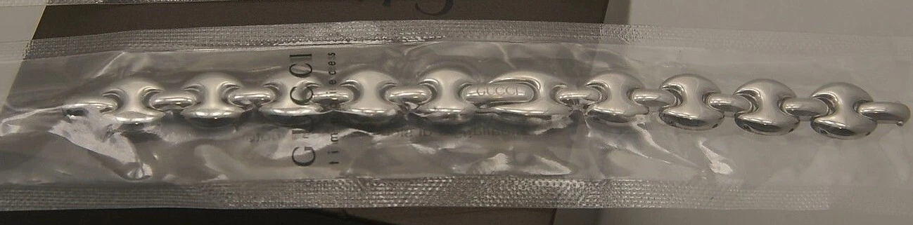 Bracelet de remplacement Gucci plaqué or et ton argent neuf dans sa boîte   1800 L   Régulier  