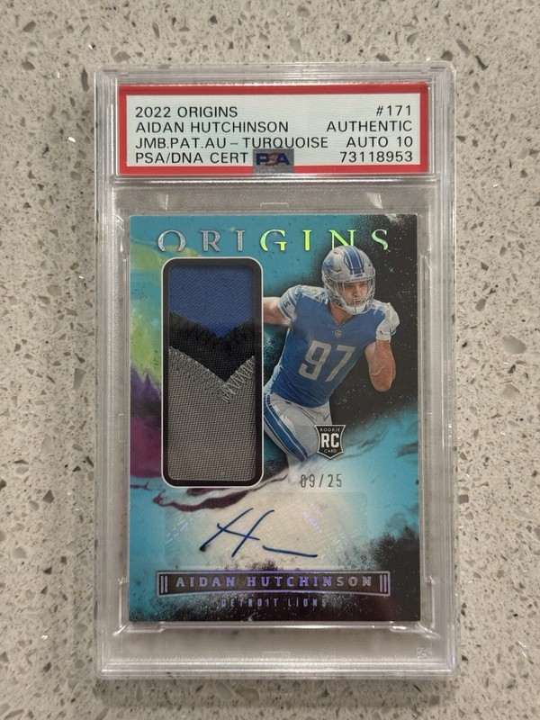 Panini Origins 2022 Aidan Hutchinson RC Jumbo Jersey Auto Turquoise /25 PSA