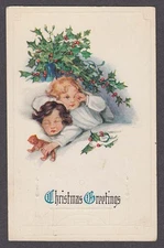 Christmas Greetings children in bed with holly embossed postcard 1915