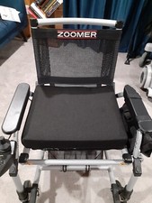 Zoomer black electric wheelchair. Comes with battery charger and manual.