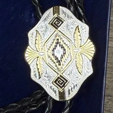 Montana silversmith black and gold  bolo tie new in box never worn