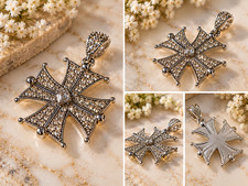 silver Maltese cross pendant features a striking central emerald-cut crystal sur