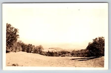 Postcard Unidentified RPPC,  Scenic View, Field, Tree Line, Mountains Beyond 