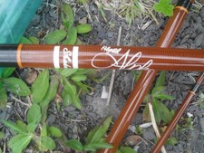 SHAKESPEARE ALPHA 3 PIECE FISHING ROD WITH CANVAS BAG AND PLASTIC CARRY TUBE.