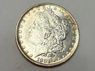 1883-O Morgan U.S. silver dollar. Satiny white BU, hint of gold. #eL1