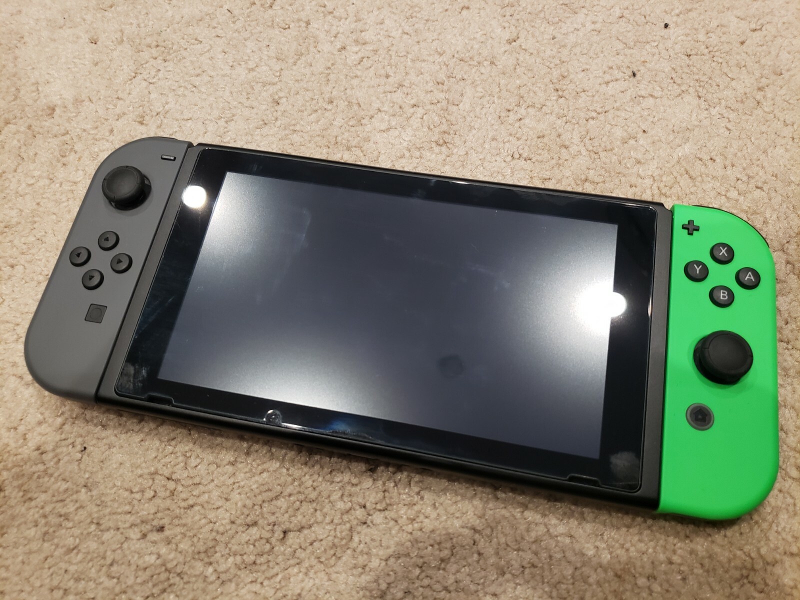 Nintendo Switch with soft, hard, and carrying case - green and black joycons-image