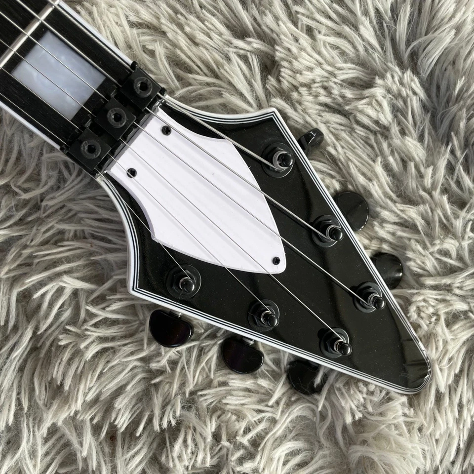 Guitarra Eléctrica Blanca Forma de V Pastillas HH Cuerpo de Caoba Herrajes Negros Puente FR Foto 2 de 4