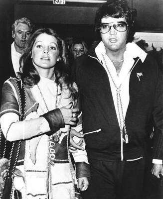 Elvis Presley and his wife Priscilla Beaulieu Presley leave the co- Old Photo