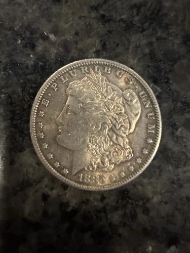 1885 O Morgan Silver Dollar. AU/BU. Some Rim Toning. No Reserve