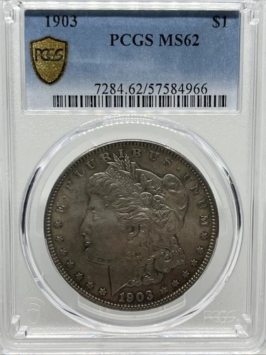 1903 MORGAN DOLLAR PCGS MS 62 WITH GOLD SHIELD AND SLIGHT TONING