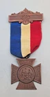 Post Civil War US Women’s Relief Corps Medal with red, white, and blue ribbon.