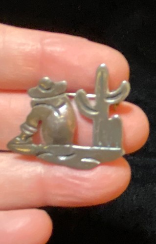 This is a vintage mid-century Taxco sterling silver "siesta man and cactus" figu