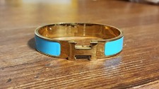 Hermès Clic H bangle bracelet featuring blue enamel and gold-plated hardware