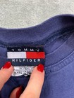 Navy long sleeve Tommy Hilfiger shirt with red, white, and blue flag design, 2XL label, and “Made in U.S.A.” text.