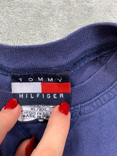 Navy long sleeve Tommy Hilfiger shirt with red, white, and blue flag design, 2XL label, and “Made in U.S.A.” text.