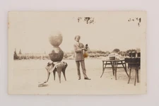 FOUND PHOTO Man With Bottle Two Spheres Stacked On Table Snapshot Vtg 1930s