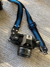 Nikon EM 35MM Camera w/50MM 1.8 Nikon Series E Lens with case and lots of extras