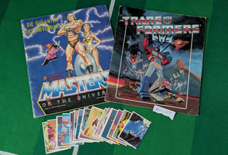 Two Panini Sticker Albums "Masters Of Universe" "Transformers" 24 Stickers