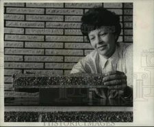 1967 Press Photo Woman Demonstrates a Lava Brick for Decorating - noa46856