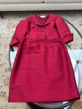 Women's dressy red two-piece silk suit with decorative buttons and slim skirt.