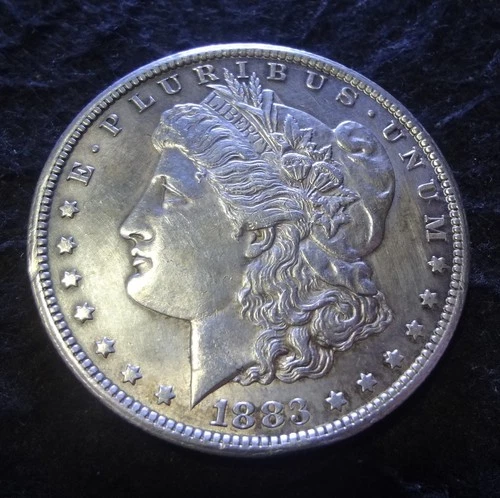 1883-CC Morgan Silver Dollar - Solid AU details from the Carson City Mint