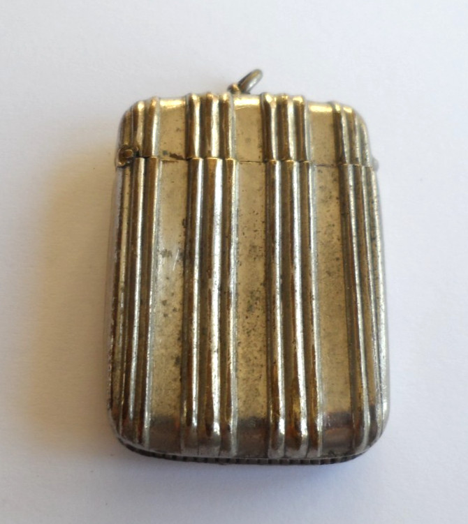 Antique white metal vesta case marked 'THE BEACON'.