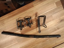Set Of Black Generic Bicycle Pedals, Bicycle Handlebar, And Bottle Holder