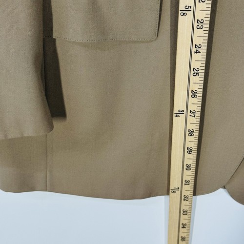 Ivory gold Austin Reed men's blazer with notch lapels, button front, and two flap pockets, shown on a measuring tape.