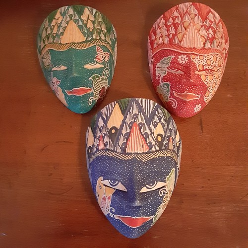 Three small painted decorative wood masks. 5 in long 3.5 in wide.
