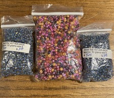 Three bags of small glass crafting beads