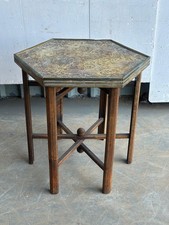 An Eastern brass topped folding occasional table