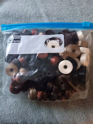 Coats Brand Small Thread Bobbins. Approximately 100 Bobbins