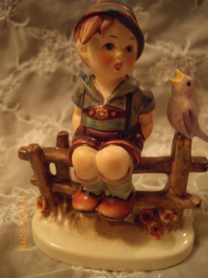 hummel boy on fence with bird