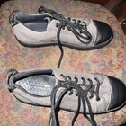 Gray Woobies men’s canvas shoes with black caps, black laces, and gray “WOOBIES” logo on textured insoles.