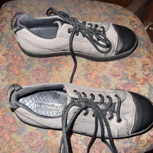 Gray Woobies men’s canvas shoes with black caps, black laces, and gray “WOOBIES” logo on textured insoles.