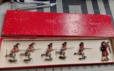 6 Britains Lead Running Black Watch Highlanders with Bagpipe Player